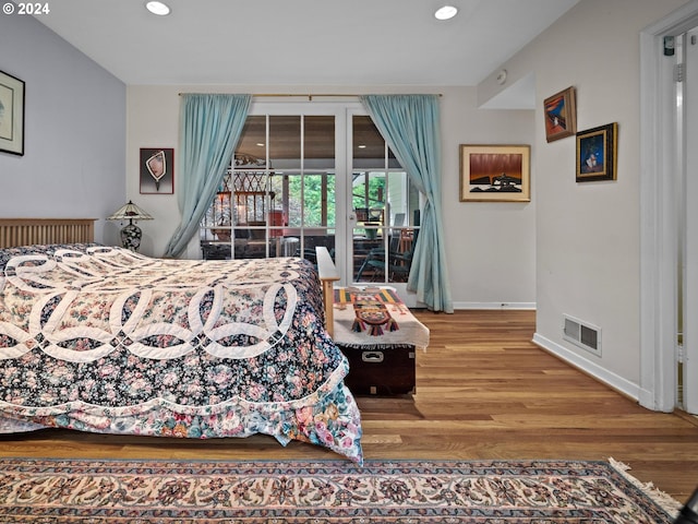 bedroom with access to exterior, baseboards, visible vents, recessed lighting, and wood finished floors