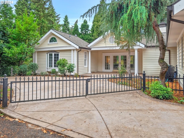 ranch-style house with a gate and a fenced front yard
