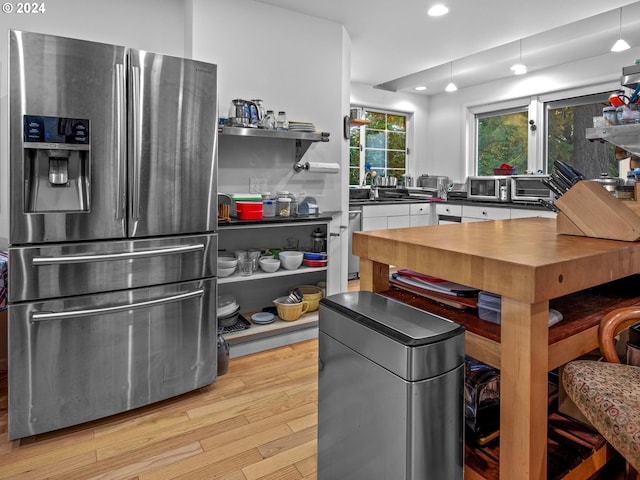 kitchen with dark countertops, open shelves, stainless steel fridge with ice dispenser, light wood finished floors, and recessed lighting
