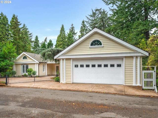 ranch-style home featuring fence private yard and a detached garage