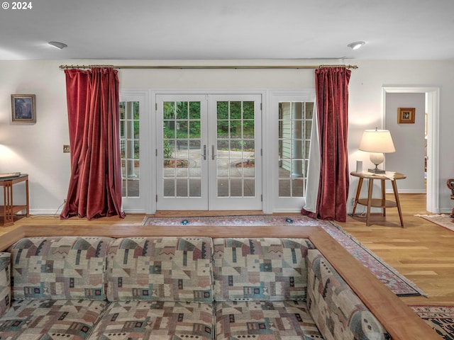 doorway with hardwood / wood-style floors and french doors