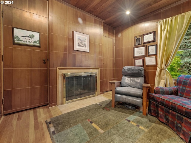 sitting room featuring recessed lighting, a glass covered fireplace, wood finished floors, and wooden ceiling
