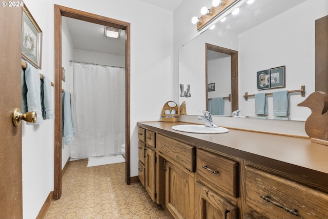 bathroom with toilet and vanity