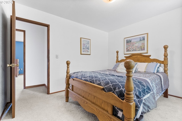 bedroom featuring light carpet