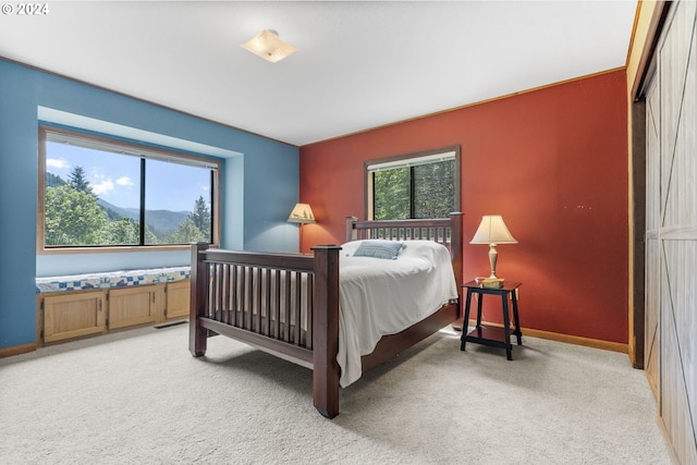 carpeted bedroom with a mountain view