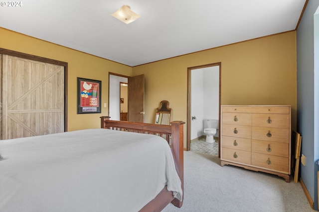 carpeted bedroom featuring ensuite bath