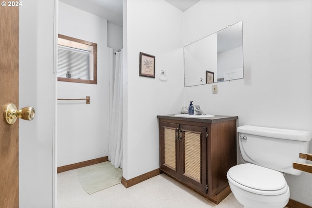 bathroom featuring toilet and vanity