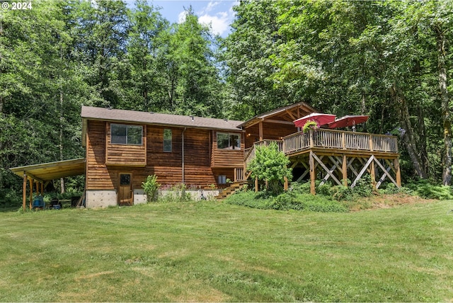 rear view of house featuring a deck and a yard