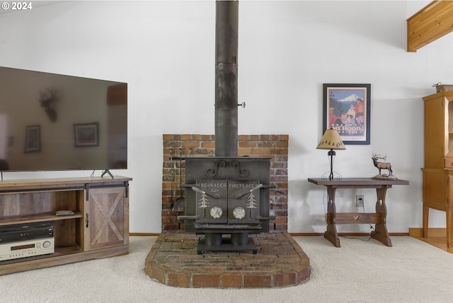 living room with carpet and a wood stove