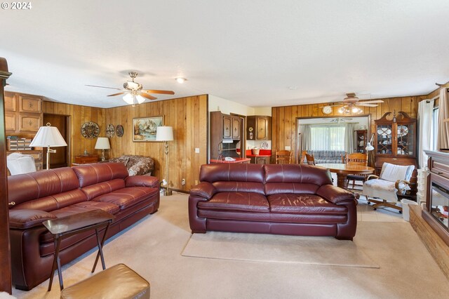 living room featuring wood walls and ceiling fan