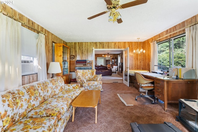 carpeted office space with cooling unit, wooden walls, ceiling fan with notable chandelier, and a textured ceiling