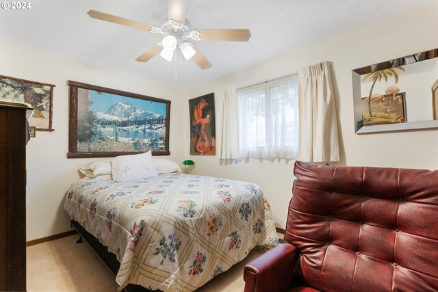 bedroom with ceiling fan and light colored carpet