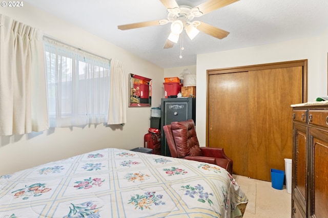 bedroom featuring ceiling fan, light colored carpet, and a closet