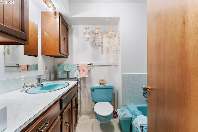 bathroom with vanity, a bathing tub, and toilet