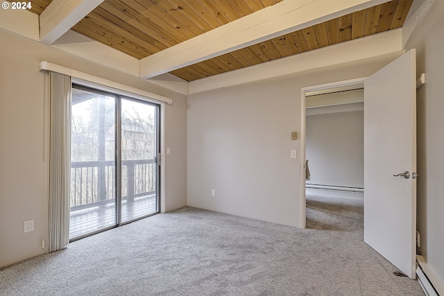 carpeted empty room featuring beam ceiling, a baseboard heating unit, and wood ceiling