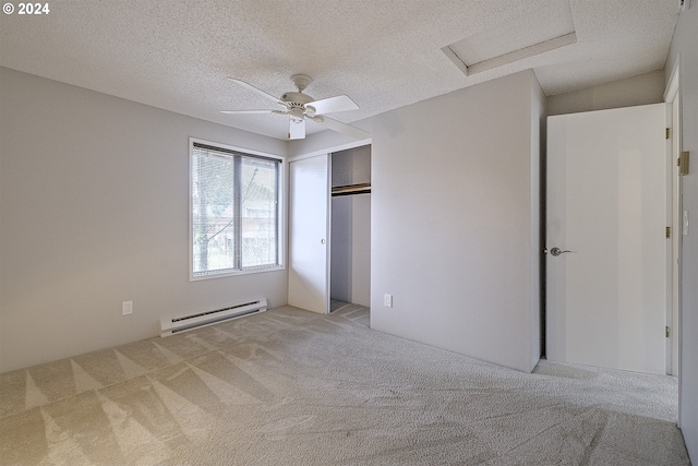 unfurnished bedroom with ceiling fan, light colored carpet, a textured ceiling, and a baseboard heating unit