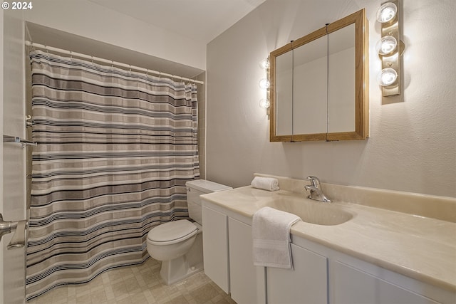 bathroom featuring vanity, toilet, and curtained shower