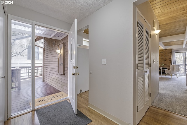 entryway featuring a textured ceiling, hardwood / wood-style flooring, and wood walls