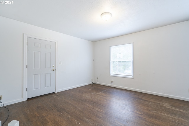 spare room with dark hardwood / wood-style floors