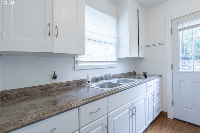 kitchen with white cabinets, dark wood-type flooring, and sink