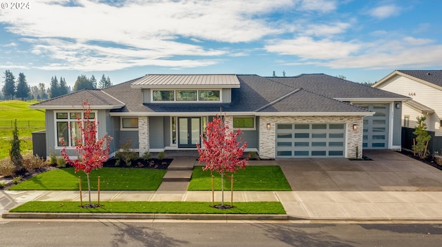 view of front of house featuring a front lawn, covered porch, and a garage