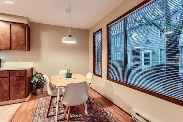 dining room featuring light hardwood / wood-style flooring and baseboard heating