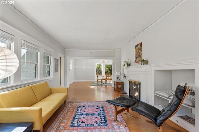 2626 SW Ravensview Dr, Portland, OR 97201 - living room with wood finished floors, a chandelier, and baseboards
