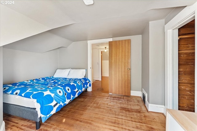 2626 SW Ravensview Dr, Portland, OR 97201 - bedroom with light wood-style floors, vaulted ceiling, and baseboards