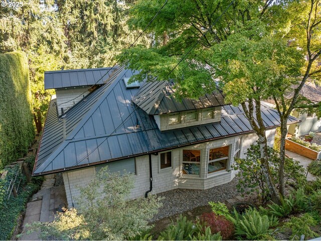 2626 SW Ravensview Dr, Portland, OR 97201 - view of side of home featuring a standing seam roof and metal roof