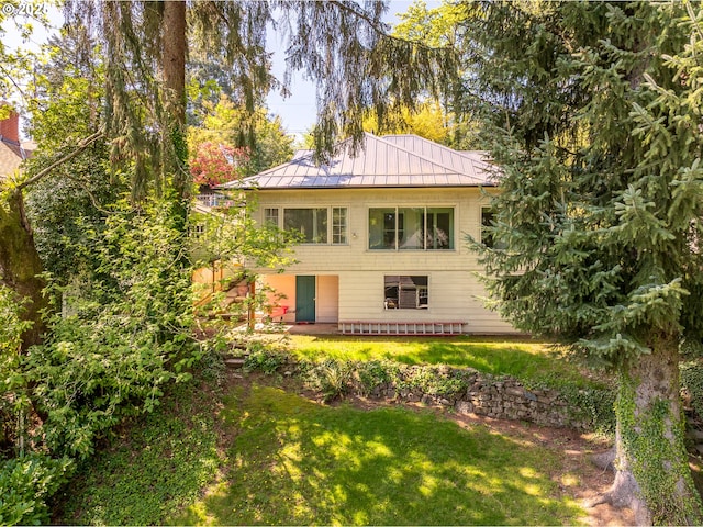 2626 SW Ravensview Dr, Portland, OR 97201 - rear view of house featuring a standing seam roof, a lawn, and metal roof