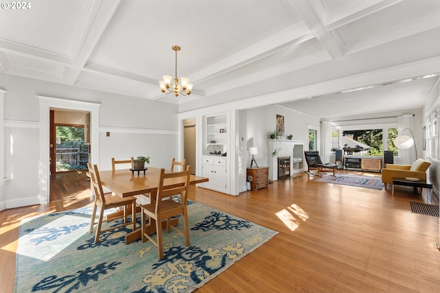 2626 SW Ravensview Dr, Portland, OR 97201 - dining space with a chandelier, a fireplace, wood finished floors, coffered ceiling, and beamed ceiling