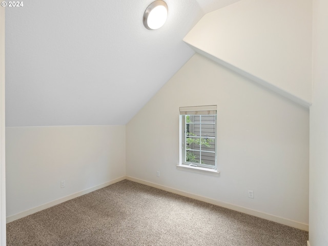 bonus room with carpet floors and lofted ceiling