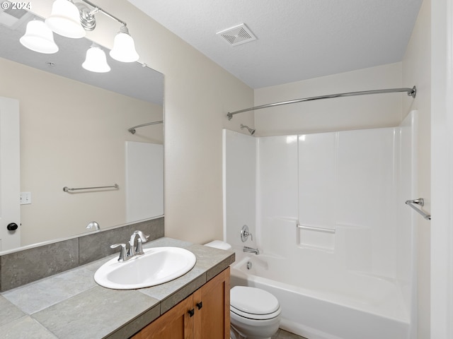 full bathroom featuring toilet, vanity, a textured ceiling, and bathing tub / shower combination