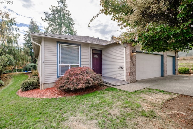 view of front of property with a front yard and a garage