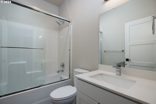 full bathroom with toilet, vanity, and shower / bath combination with glass door