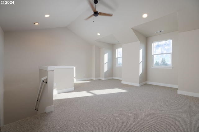 interior space with ceiling fan, light carpet, and vaulted ceiling