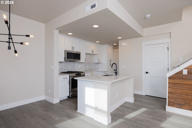 kitchen featuring white cabinetry, sink, a kitchen island with sink, and appliances with stainless steel finishes