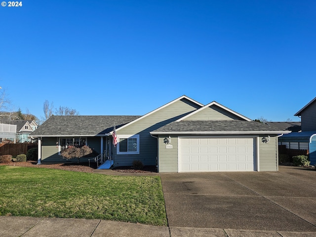 ranch-style house with a garage and a front lawn