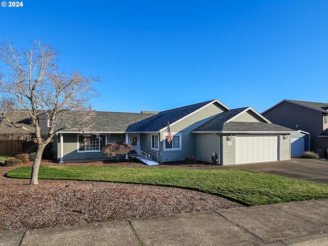 ranch-style house featuring a front yard and a garage