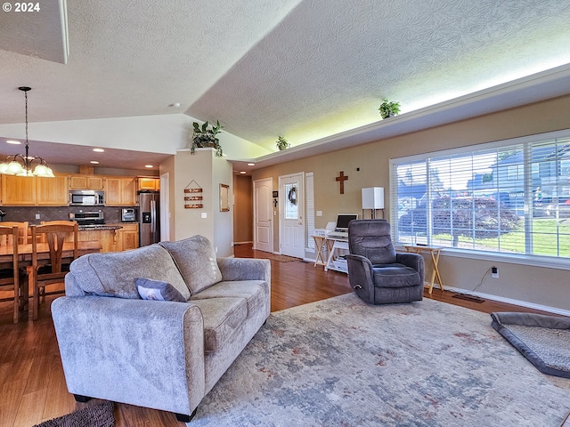 living room featuring a textured ceiling, dark hardwood / wood-style flooring, lofted ceiling, and a notable chandelier