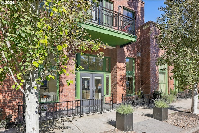 exterior space featuring a balcony and french doors