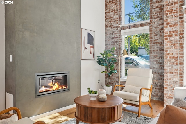 living room featuring wood-type flooring and a towering ceiling