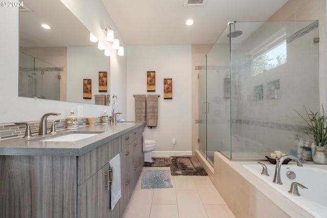 full bathroom with plus walk in shower, tile patterned floors, toilet, and vanity