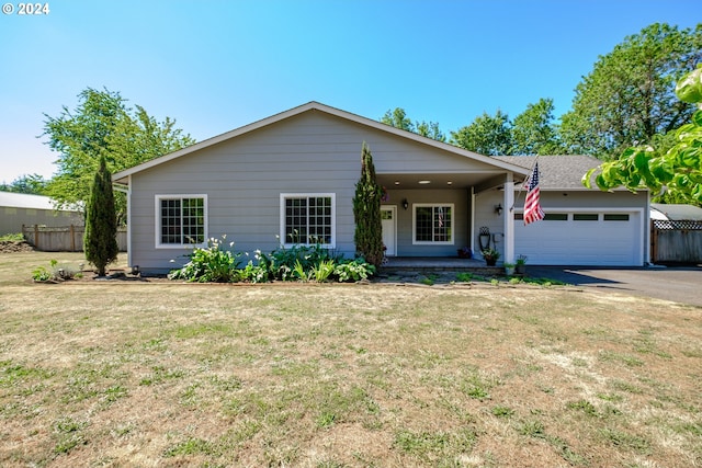 ranch-style house featuring a garage and a front lawn