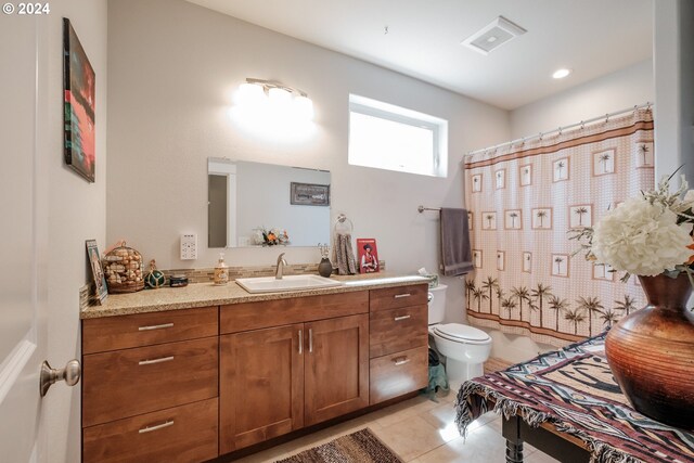 bathroom with vanity, toilet, and tile patterned floors