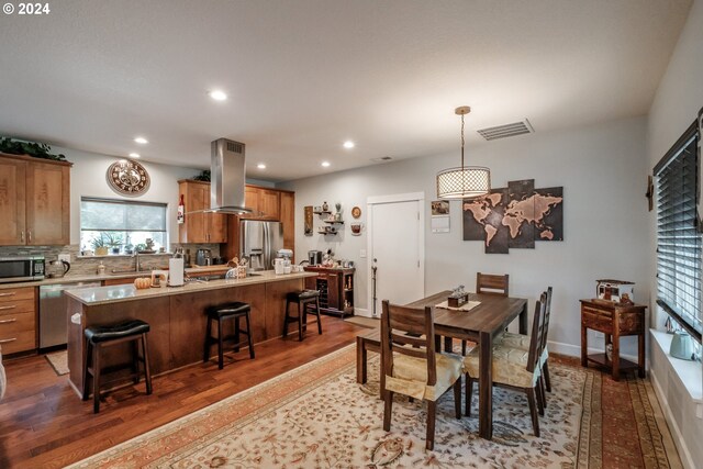 dining room featuring dark wood-type flooring and sink