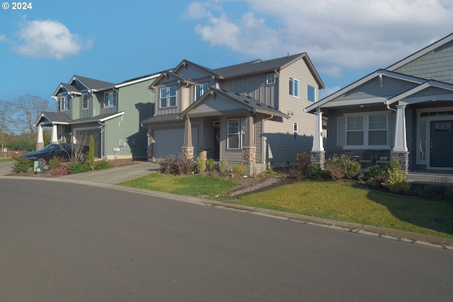 craftsman house featuring a front yard and a garage