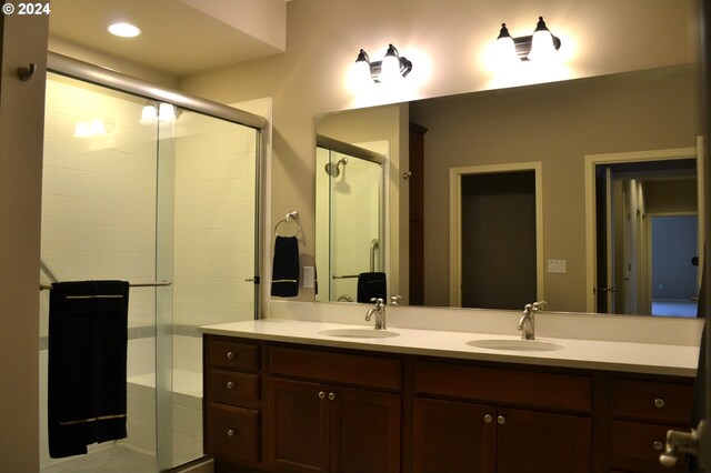 bathroom featuring vanity and an enclosed shower