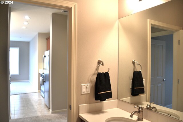 bathroom with tile patterned floors and vanity