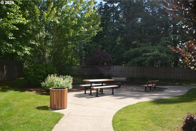 view of home's community featuring a yard and a patio area